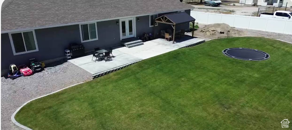Back of house featuring roof with shingles, a patio, and entry steps