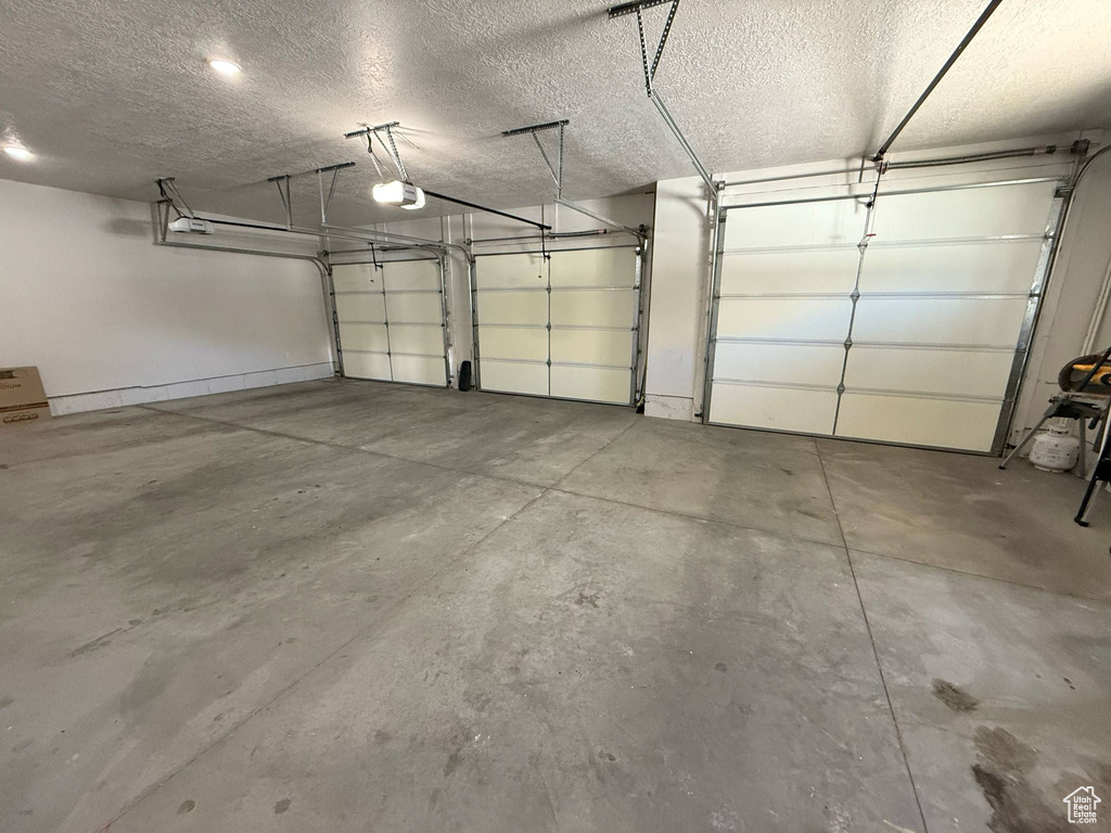 Garage featuring a garage door opener