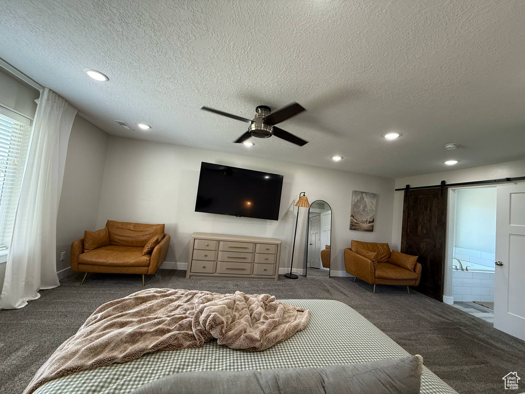 Bedroom featuring carpet, recessed lighting, a textured ceiling, arched walkways, and baseboards