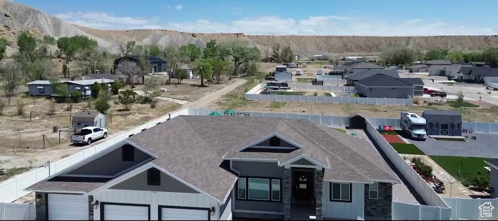 Aerial perspective of suburban area featuring a mountainous background