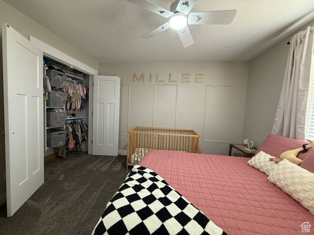 Bedroom with carpet floors, a closet, ceiling fan, and a textured ceiling
