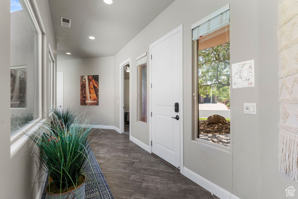 Entryway with recessed lighting, baseboards, and dark wood-type flooring