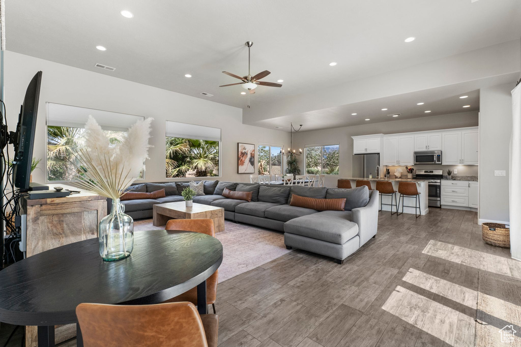 Living area with recessed lighting, ceiling fan, and light wood-style flooring
