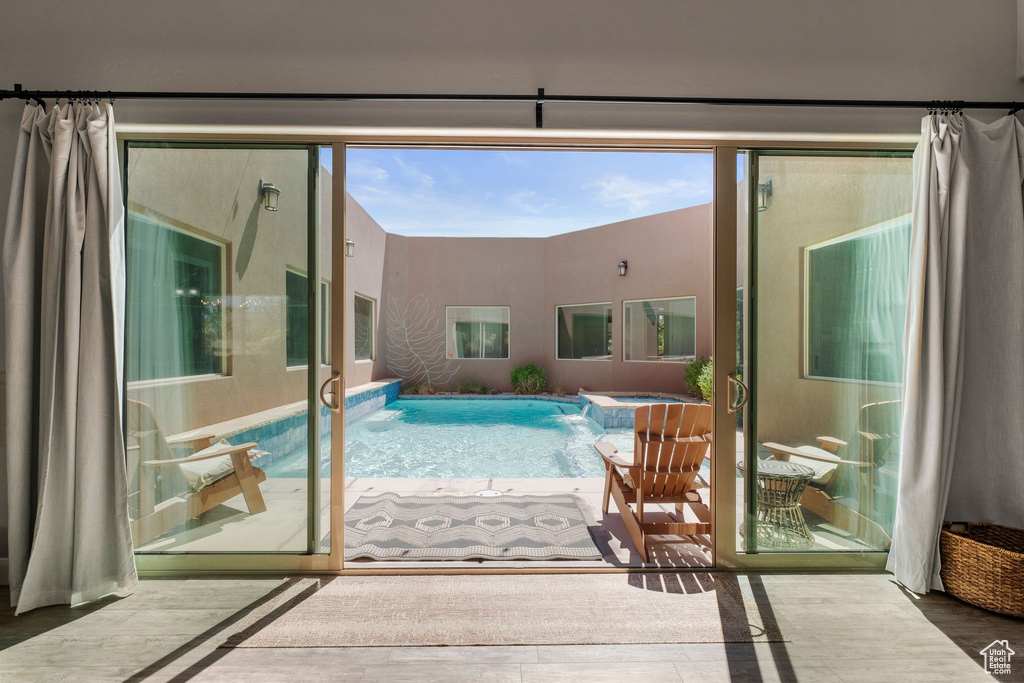 View of pool with a pool with connected hot tub