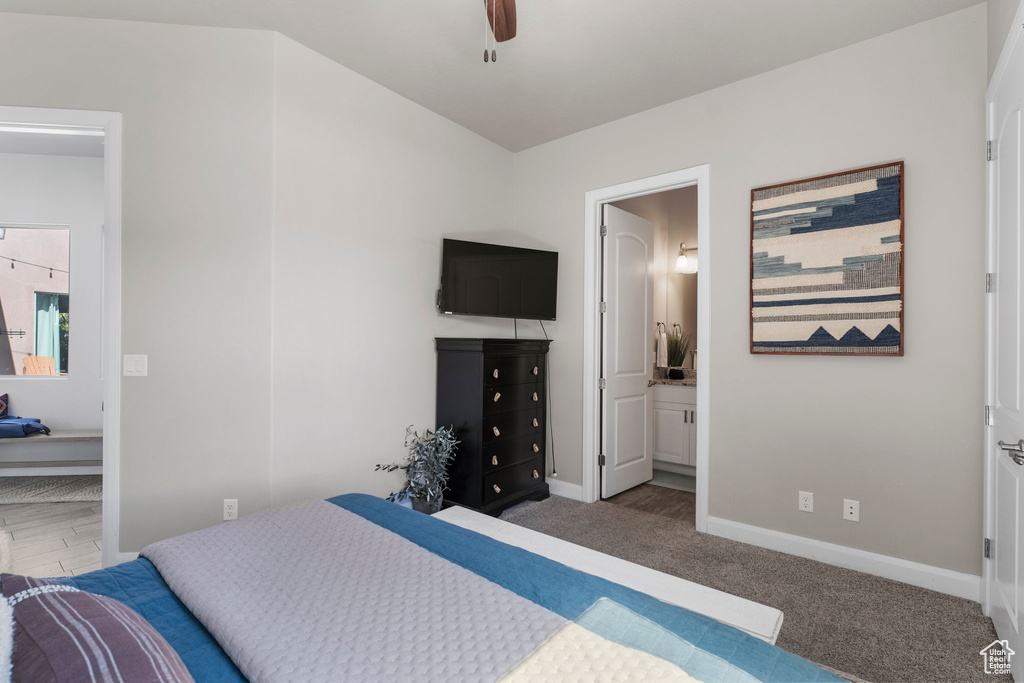 Bedroom with baseboards, carpet floors, ensuite bathroom, and ceiling fan