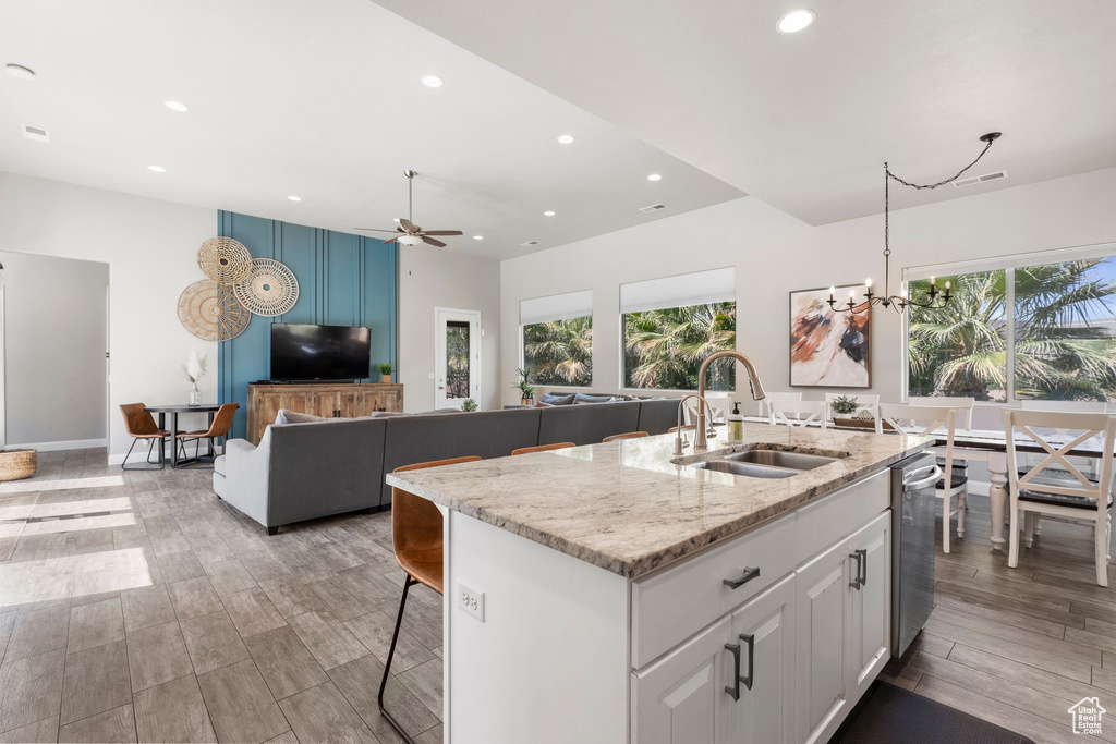 Kitchen with a sink, recessed lighting, plenty of natural light, white cabinetry, and ceiling fan