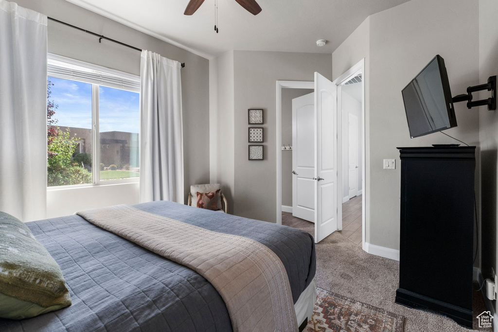 Bedroom with carpet floors, baseboards, and ceiling fan