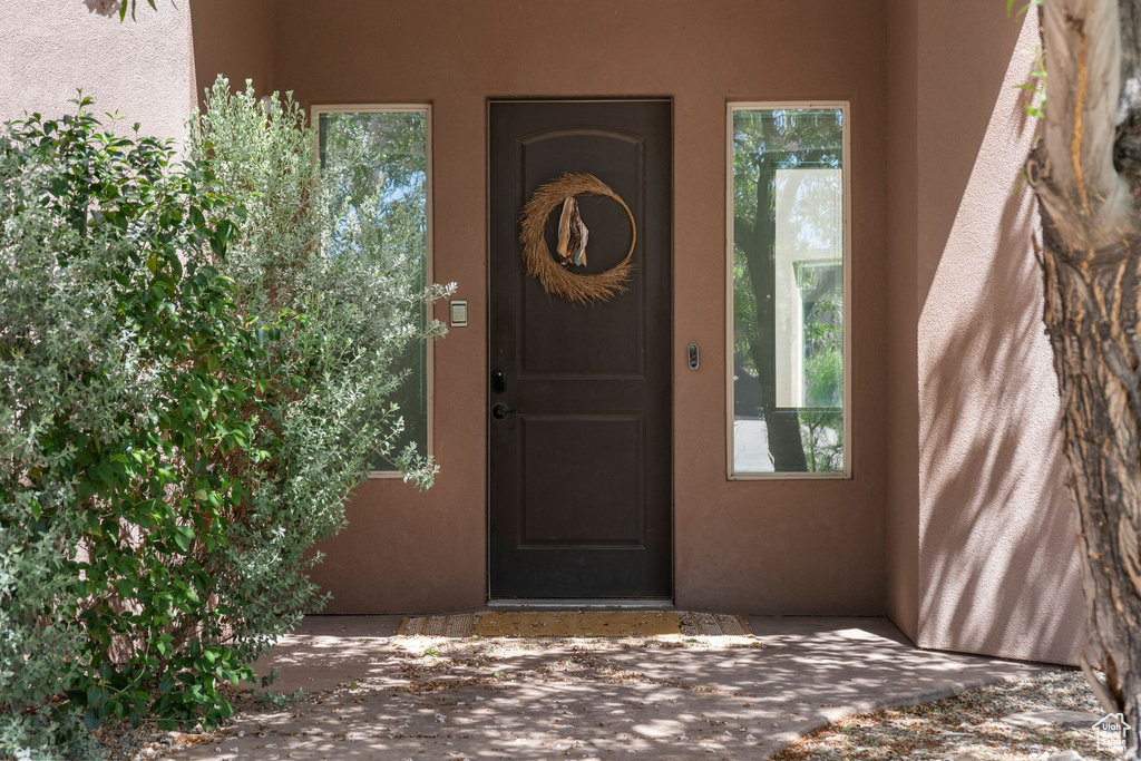 Doorway to property with stucco siding and a patio