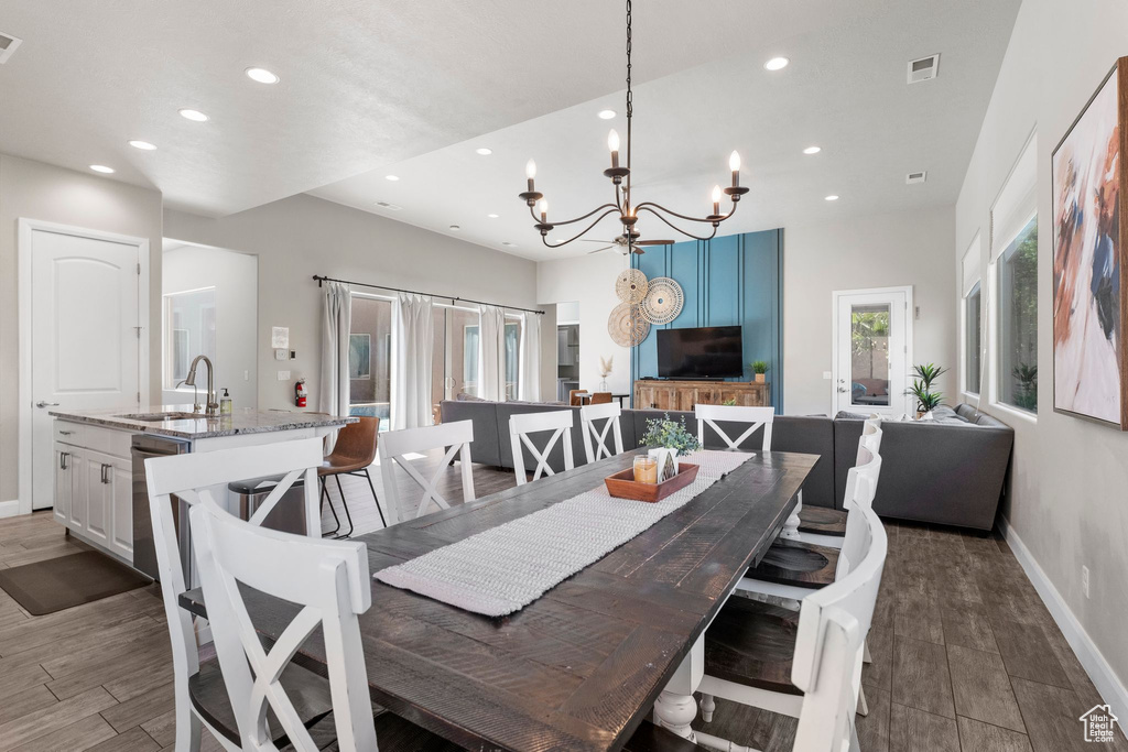 Dining room featuring recessed lighting, a chandelier, baseboards, and wood finished floors
