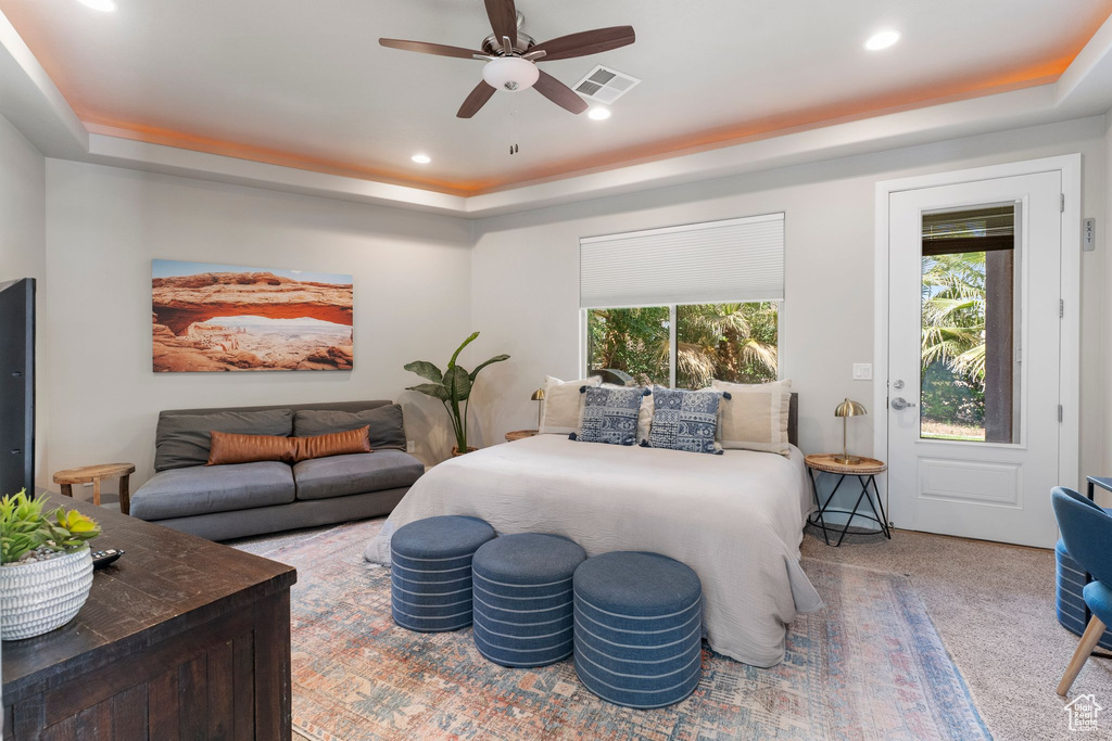 Bedroom with a tray ceiling, recessed lighting, carpet, and ceiling fan