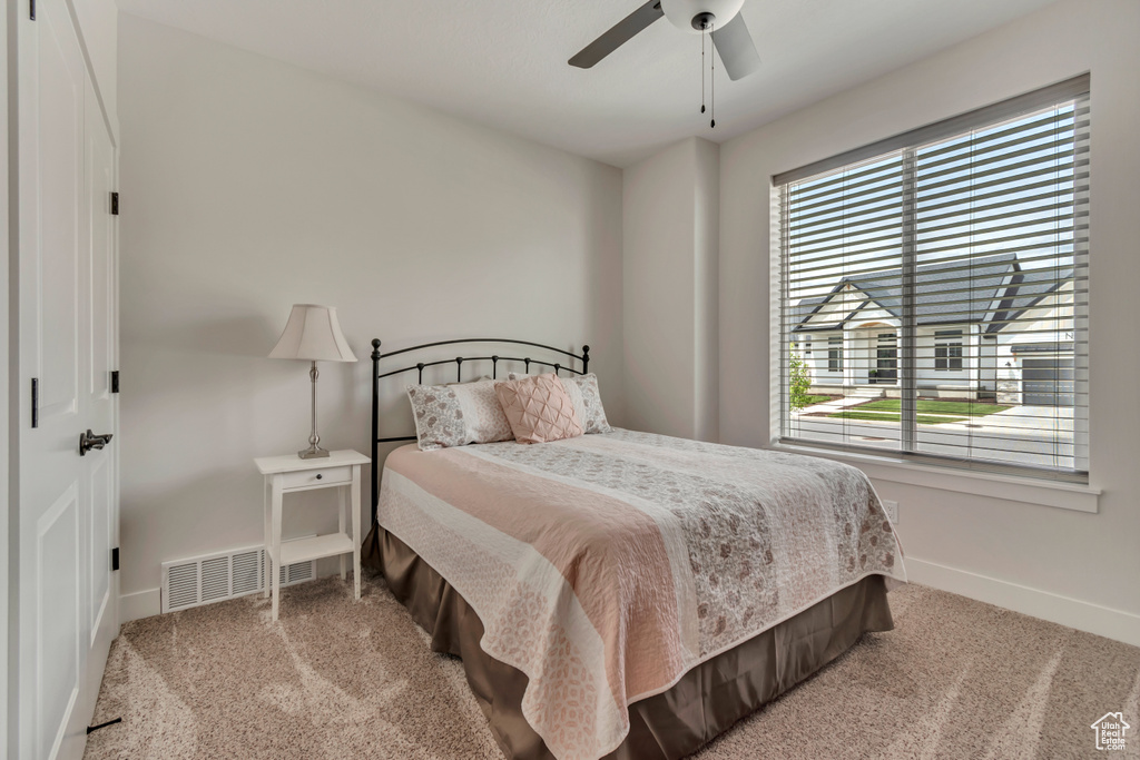 Bedroom with baseboards, carpet, and a ceiling fan