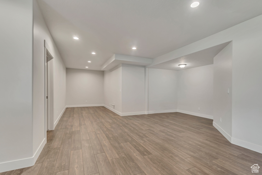 Finished basement with recessed lighting, wood finished floors, and baseboards