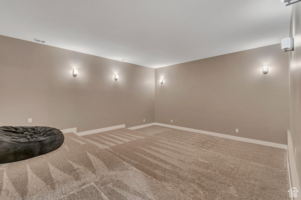 Unfurnished room with light carpet and baseboards