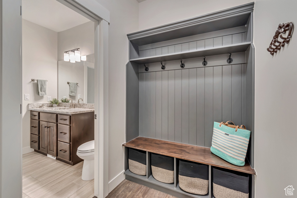 Mudroom featuring baseboards and light wood-style floors