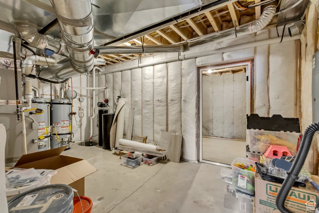 Unfinished basement featuring water heater