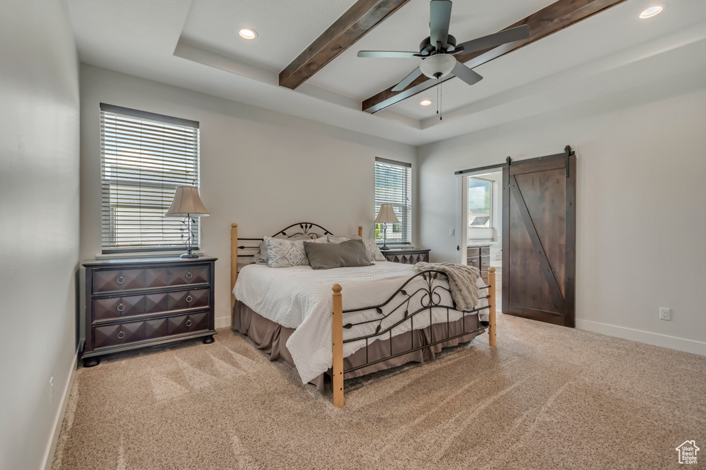 Bedroom with recessed lighting, beam ceiling, a barn door, light colored carpet, and baseboards