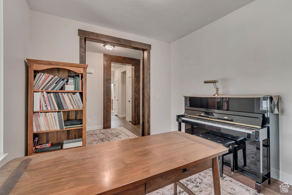 Home office featuring wood finished floors and baseboards