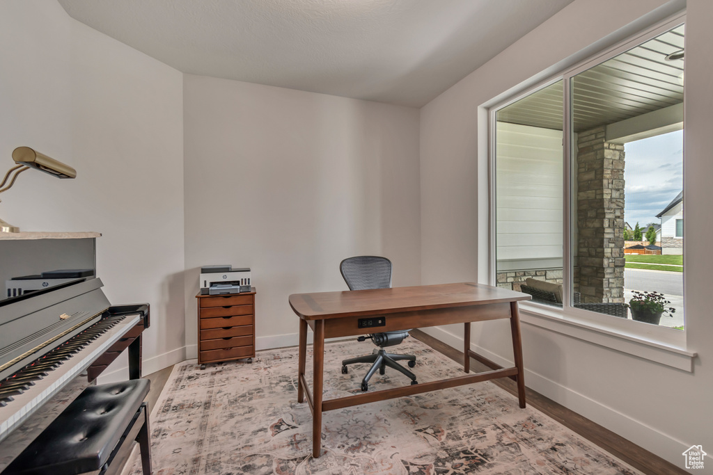 Office area with baseboards and wood finished floors