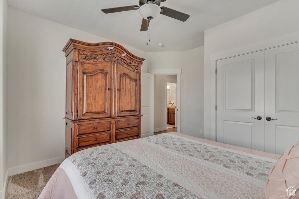 Bedroom featuring baseboards, a closet, carpet, and ceiling fan