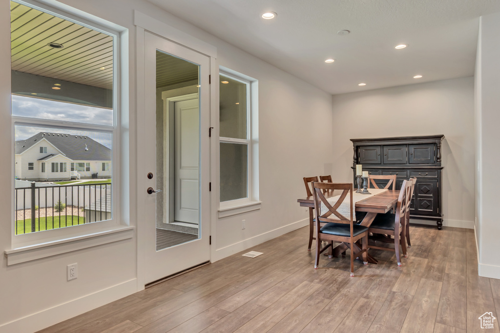 Dining space featuring baseboards, light wood-style flooring, and recessed lighting