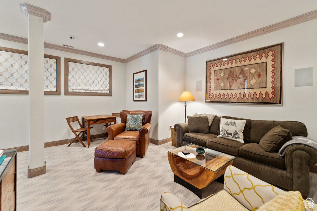 Living room with baseboards, ornate columns, recessed lighting, and crown molding