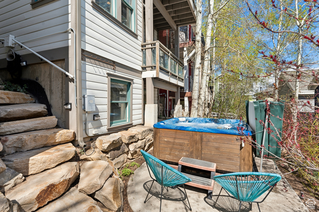 View of patio with a hot tub