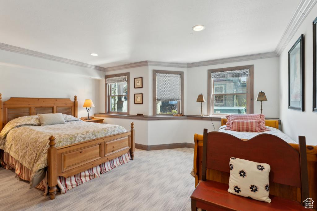 Bedroom with baseboards, light wood-style flooring, crown molding, and recessed lighting