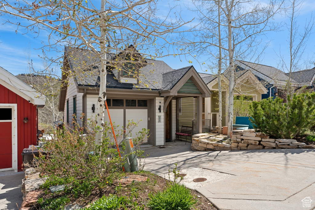 View of front facade with driveway and a garage