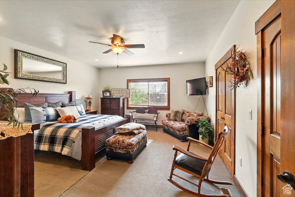 Bedroom featuring carpet floors, ceiling fan, and recessed lighting