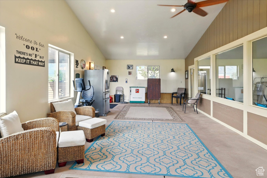 Living room featuring ceiling fan, recessed lighting, high vaulted ceiling, and concrete floors