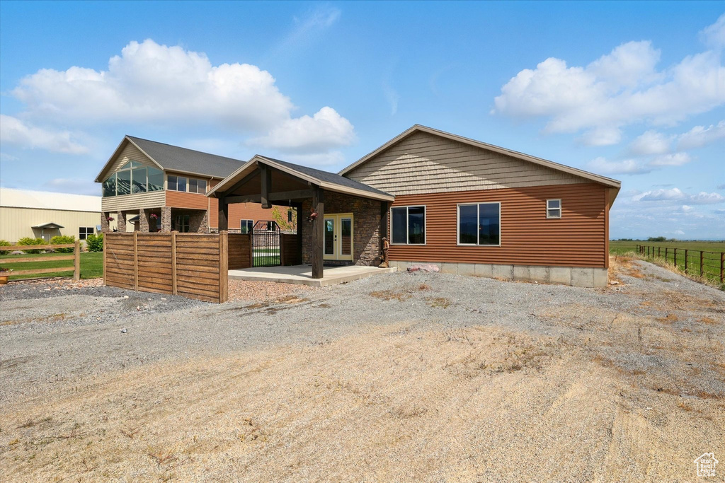 View of front of property with fence and french doors