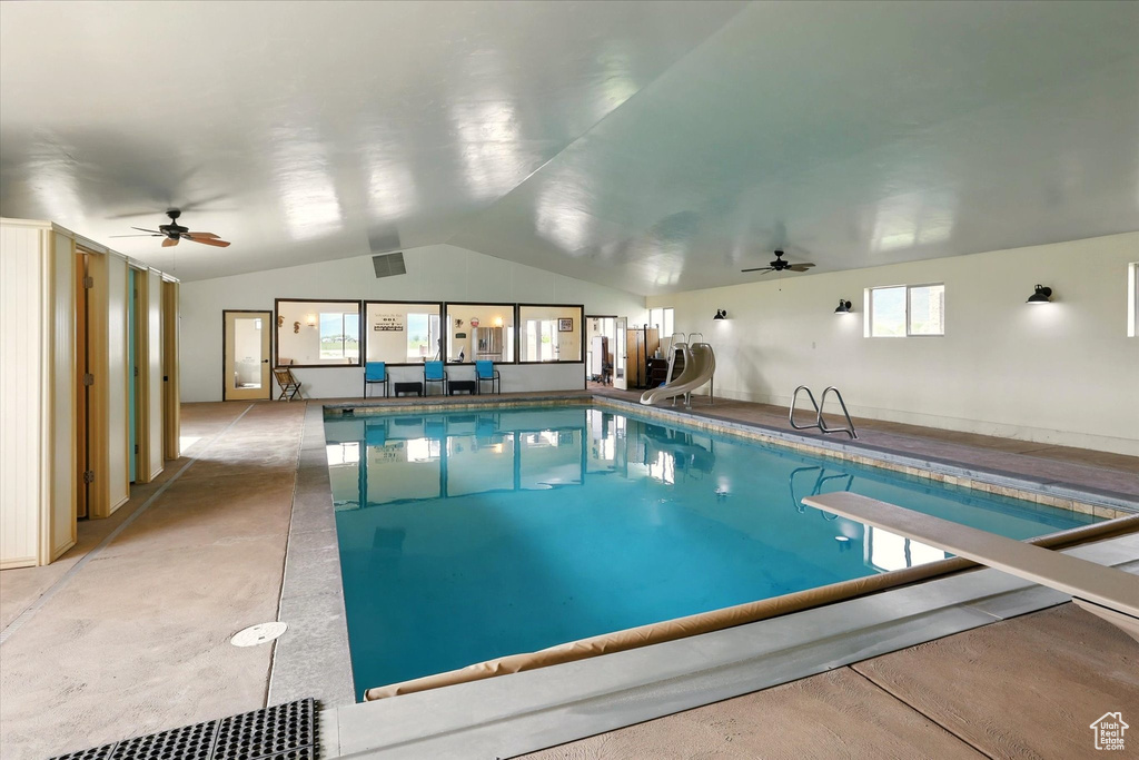 Indoor pool featuring ceiling fan