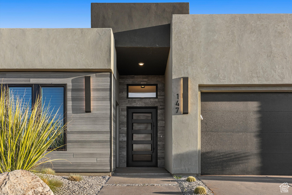 Property entrance featuring stucco siding