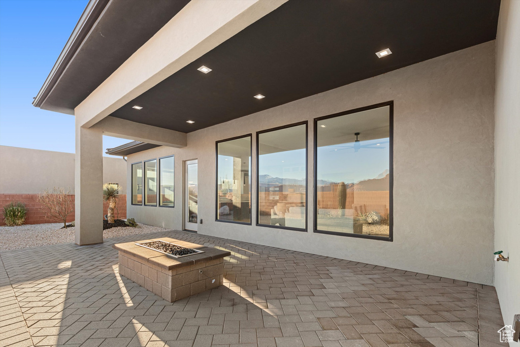 View of patio / terrace with a fire pit and fence