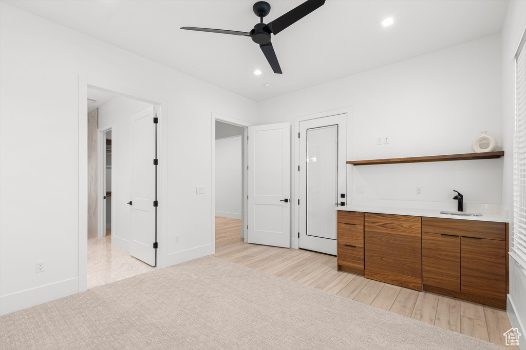 Unfurnished bedroom featuring recessed lighting, light wood finished floors, baseboards, wet bar, and a ceiling fan