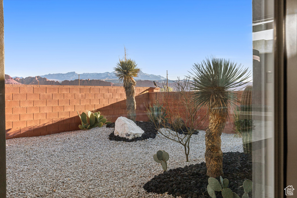Fenced backyard featuring a mountain view