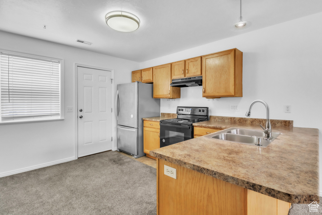 Kitchen featuring electric range, a sink, freestanding refrigerator, under cabinet range hood, and light colored carpet