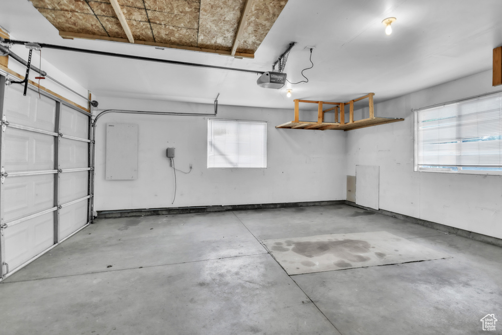 Garage featuring a garage door opener