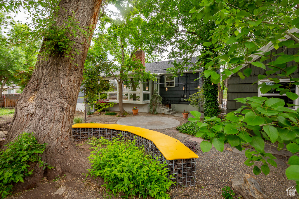 View of yard featuring fence and a patio