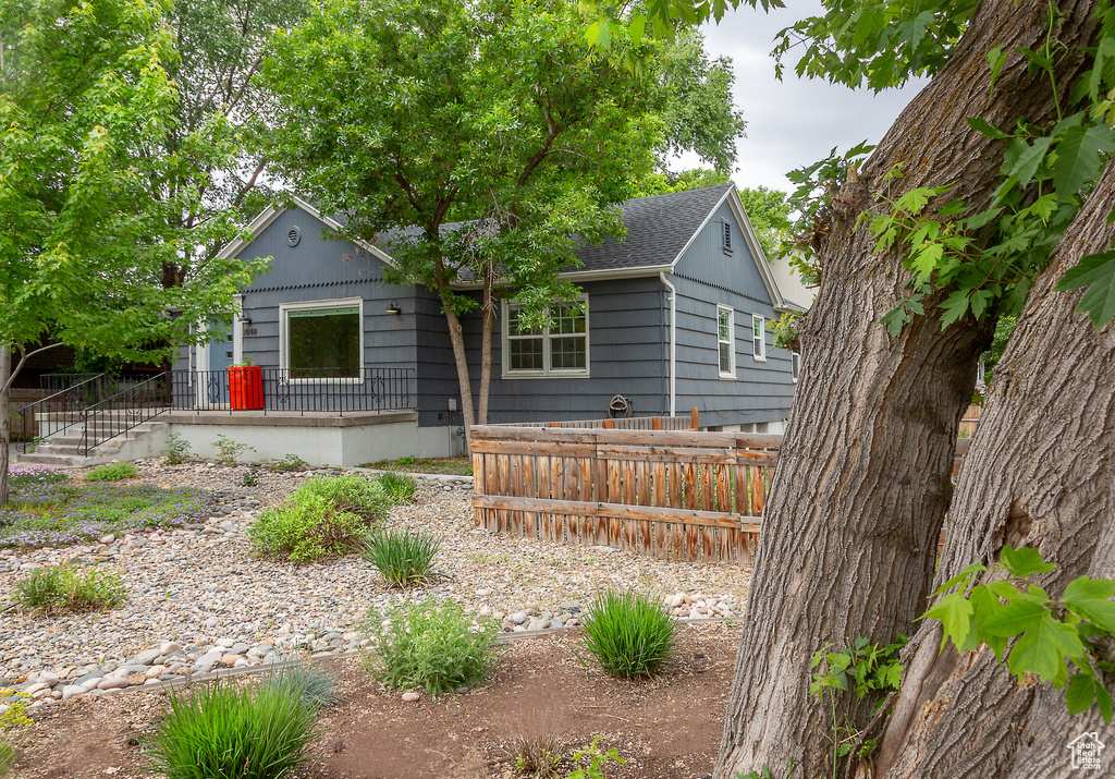 View of front of home featuring fence