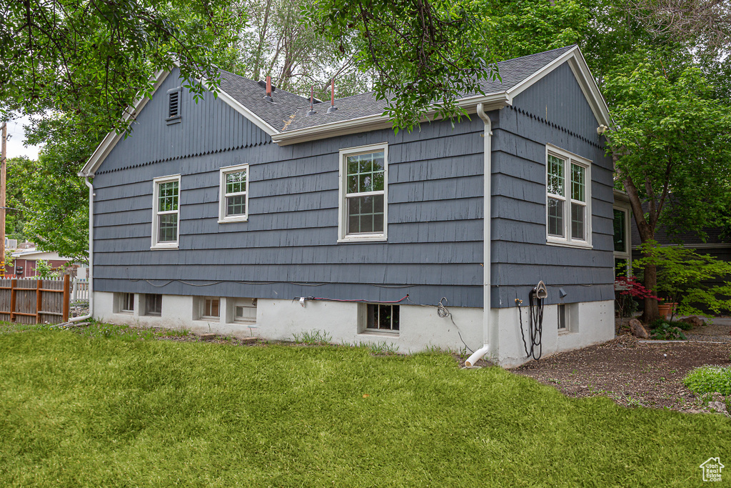 View of home\\\'s exterior featuring a shingled roof