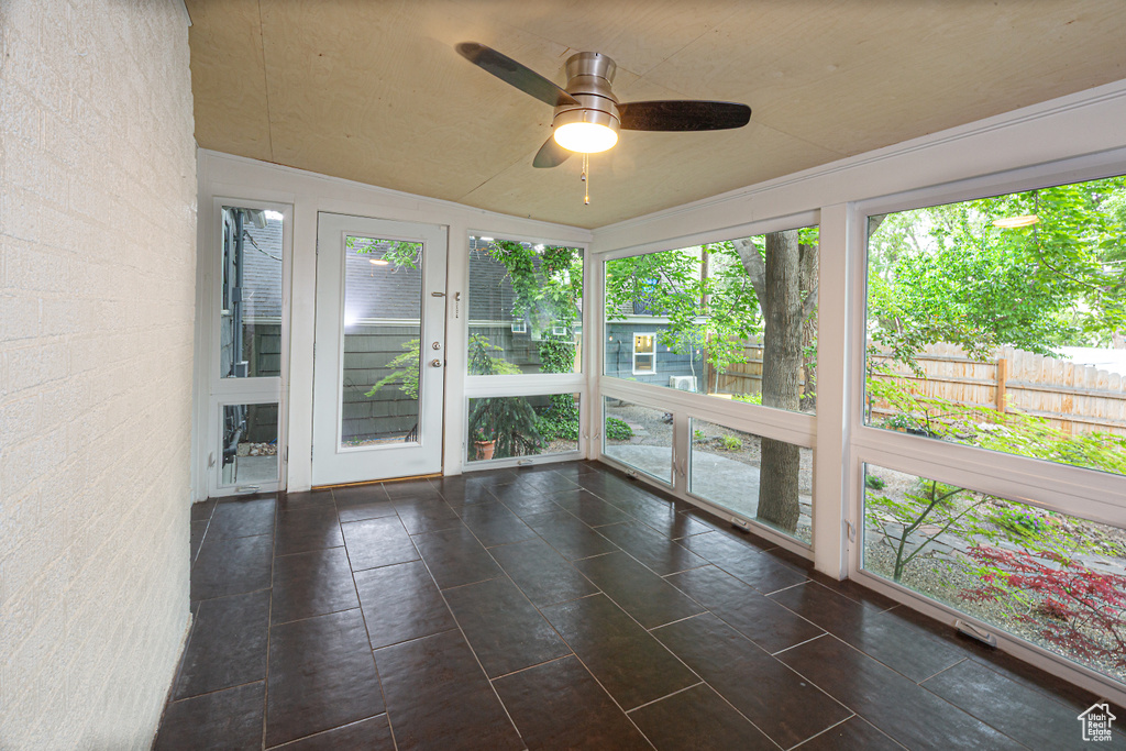 Unfurnished sunroom featuring lofted ceiling