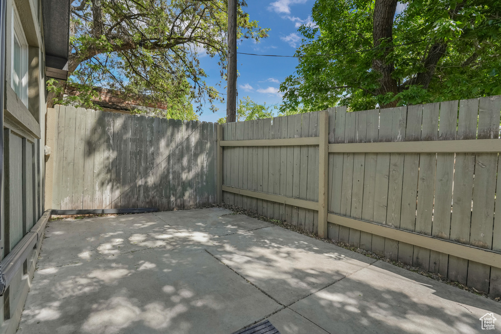 View of patio featuring fence