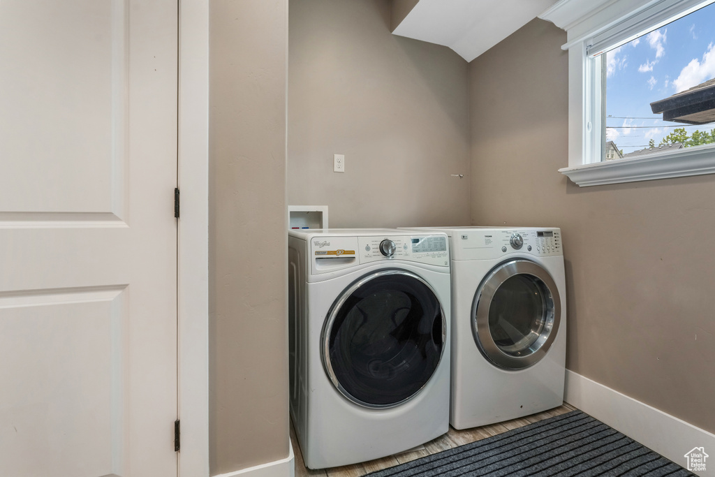 Laundry area featuring washing machine and clothes dryer and baseboards