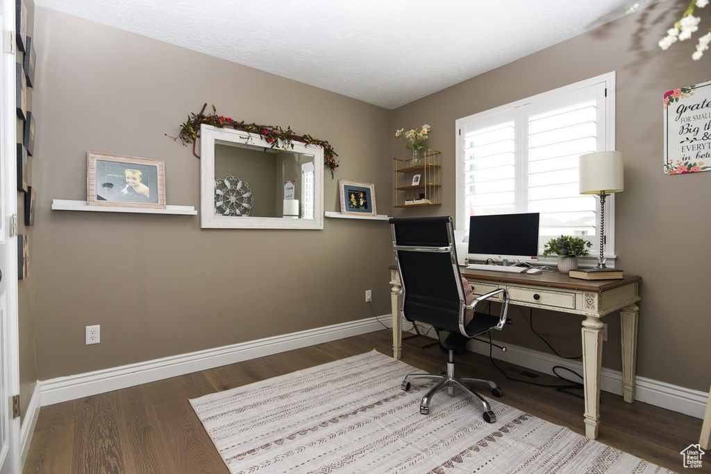 Office area with wood finished floors and baseboards