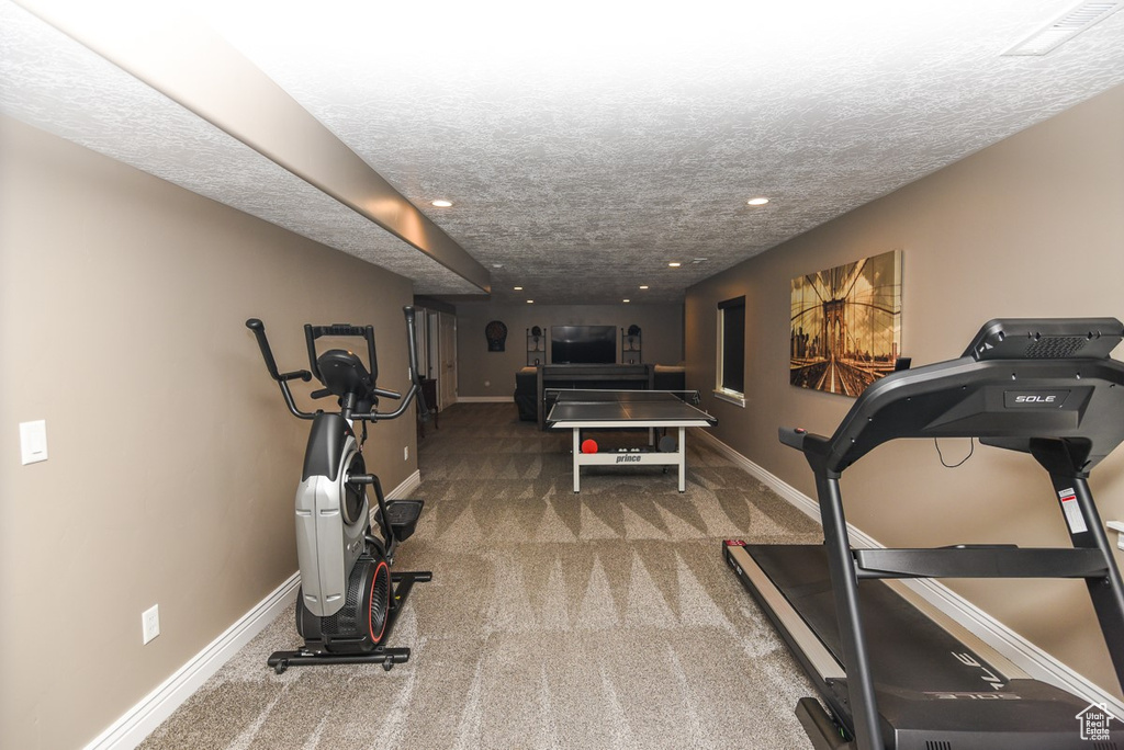 Workout area with carpet, recessed lighting, baseboards, and a textured ceiling