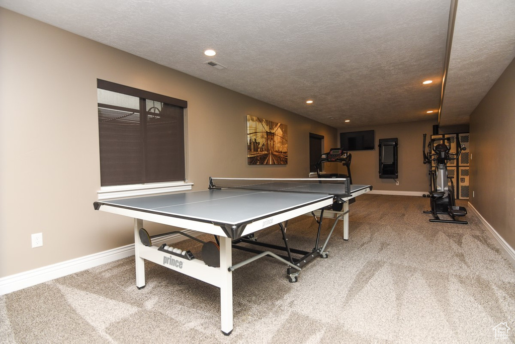 Recreation room featuring recessed lighting, carpet, baseboards, and a textured ceiling