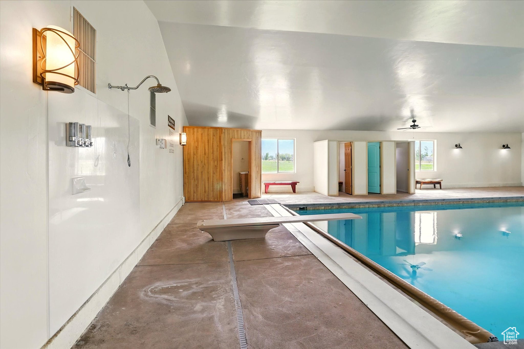 Indoor pool featuring a diving board