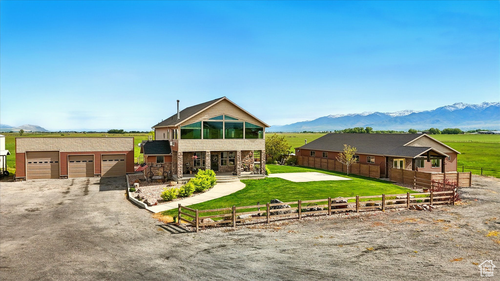 View of front of property with a mountain view and a detached garage