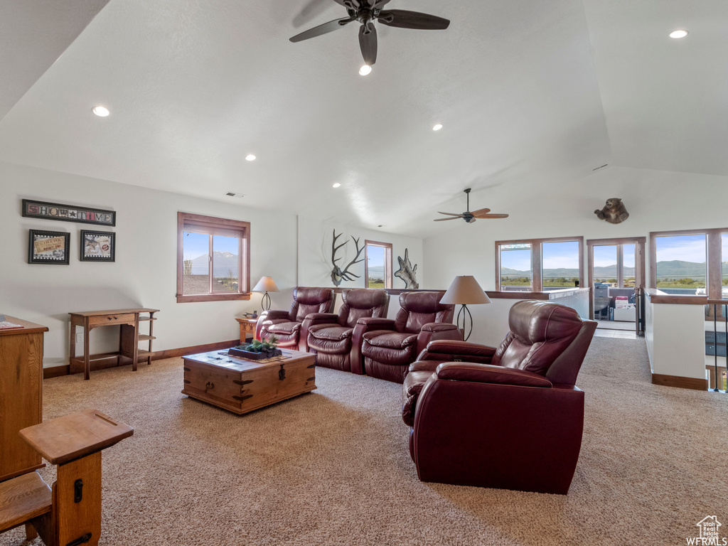 Living room featuring ceiling fan, carpet floors, lofted ceiling, recessed lighting, and baseboards